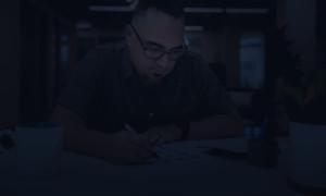 Jon Merlin Working At A Desk